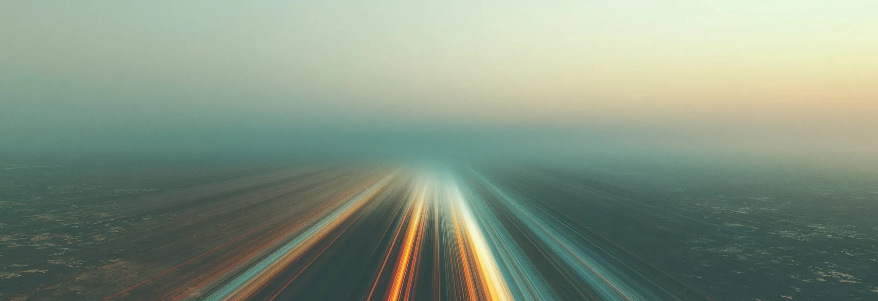 An abstract image of bright lines rushing towards the horizon